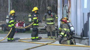 Firefighters enter a burning building as part of training. (FILE)