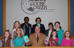 (L to R):  First Row: Elle Wilson, Abi Noy, Mayor Michael Heitzler, Rhiannan Gottlieb, Milena Fix Second Row: Charlise Fischetti, Loretta Graham (CEO, Girl Scouts of Eastern South Carolina), Wendy Blair (Field Director, Girl Scouts of Eastern South Carolina), Donna Lee (Communications Manager, Girl Scouts of Eastern South Carolina), Caitlyn Hester  