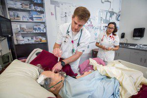 Trident Technical College students Charles Tilley and Angelina Barchi practice their nursing skills using a patient simulator in the college’s new Nursing and Science Building. Instructors can program the simulators to create a variety of health care scenarios.