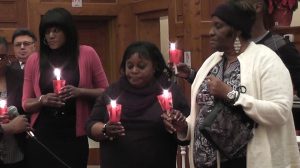 Reese's family lights a candle in his honor.
