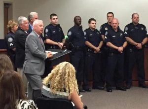 Pictured: Duane Lewis speaks before administering the oath of office to Will Rogers (Via Bill Burr/Twitter)