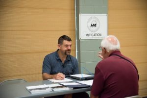 A FEMA Mitigation specialist provides information to a flood survivor at the Disaster Recovery Center (DRC) in Foley Beach, SC. FEMA is working with local, state, private and other federal agencies to provide assistance to South Carolina flood survivors. Photo by Patsy Lynch/FEMA