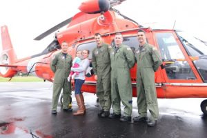 Cristi Mueller, second from left, holds her infant daughter, Kailynn Walts, next to the Coast Guard Air Station Savannah, Georgia crew who came to their rescue Oct. 4, 2015 in Huger, S.C. Mueller and her daughter were hoisted from an area that was inundated with significant flooding. (U.S. Coast Guard photo by Petty Officer 2nd Class Anthony L. Soto)