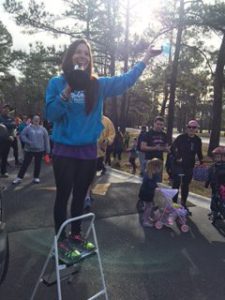Fit Family 5k founder Heather Faas addresses attendees, prays for group.