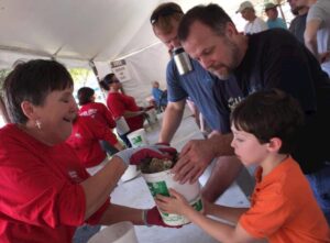 A father and son grab a bucket of oysters to share.