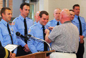 Dozens of family, friends and supporters were on hand as 14 new firefighters received their badge.