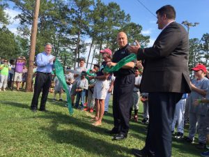 Athletic Director Clyde King officially cuts ribbon at the refurbished field.