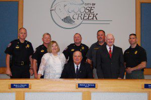 Pictured: Goose Creek Mayor Michael Heitzler (front row, center) is pictured with (front row, l-r) Mary Ann Deese, Harold Deese, (back row) Goose Creek Police Major John Grainger, Chief Harvey Becker, Captain Shawn Laffey, Captain Dave Soderberg and Captain Dave Aarons.