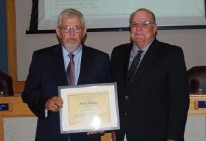 Goose Creek Mayor Michael Heitzler (right) presents a certificate from the Economic Development Institute to Mayor Pro Tem Phillips