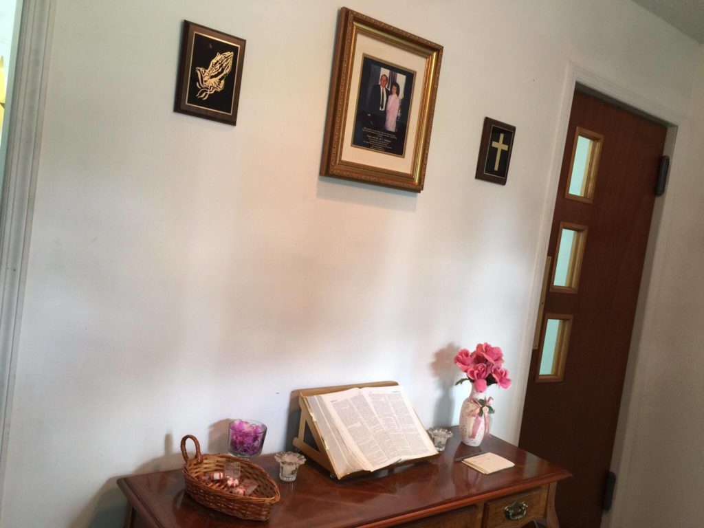 A framed picture of Pastor and Mrs. M.C. Williams greets guests as they enter the chapel.