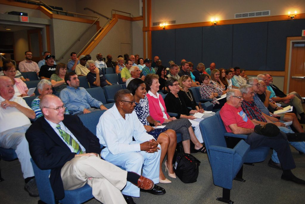A full City Council chamber listens as Dennis Harmon is awarded the Order of the Silver Crescent.