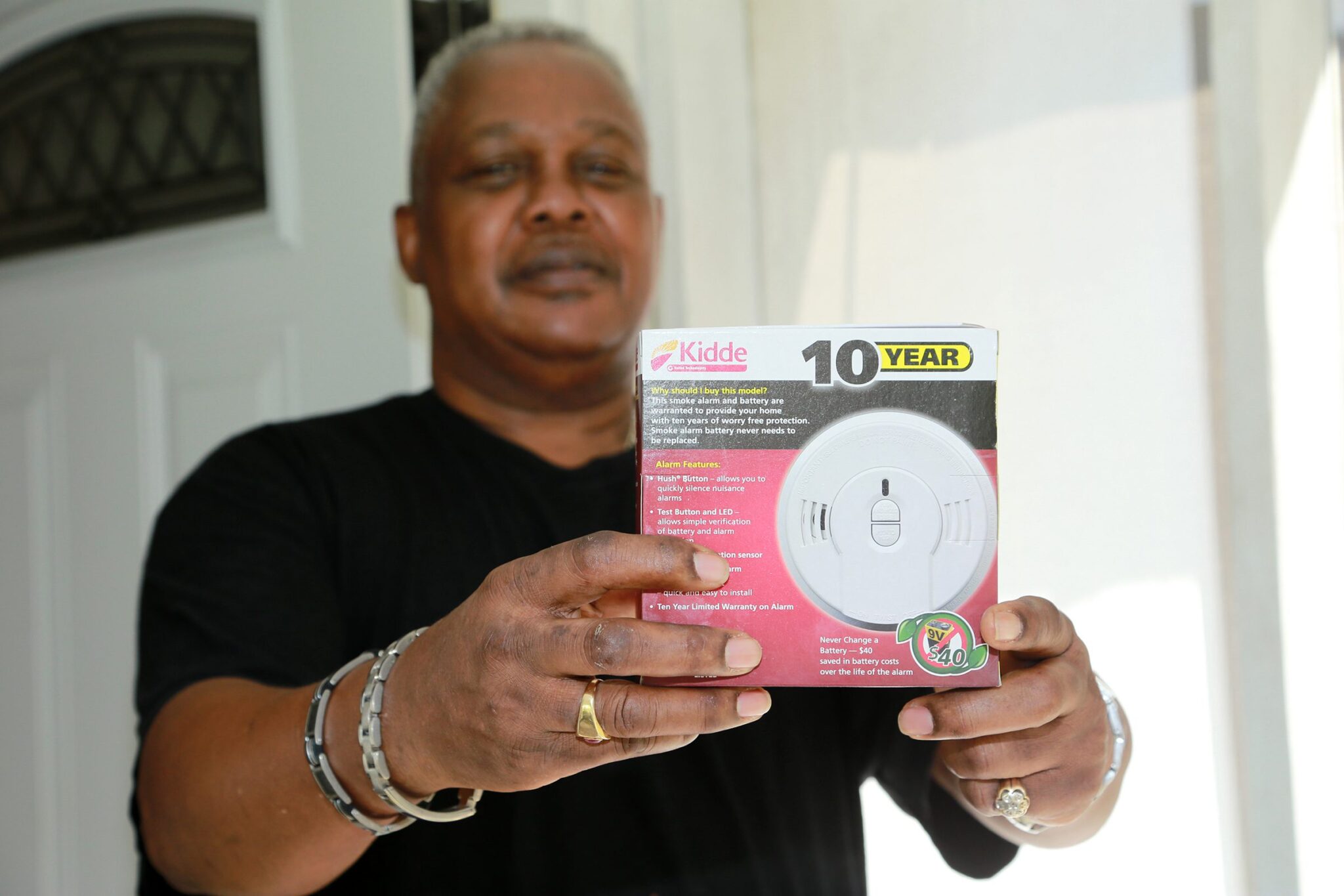 Local electrician and BEC member, Carlton Wilson, shows off one of the four smoke detectors installed in his home through a new partnership between the American Red Cross and Berkeley Electric.