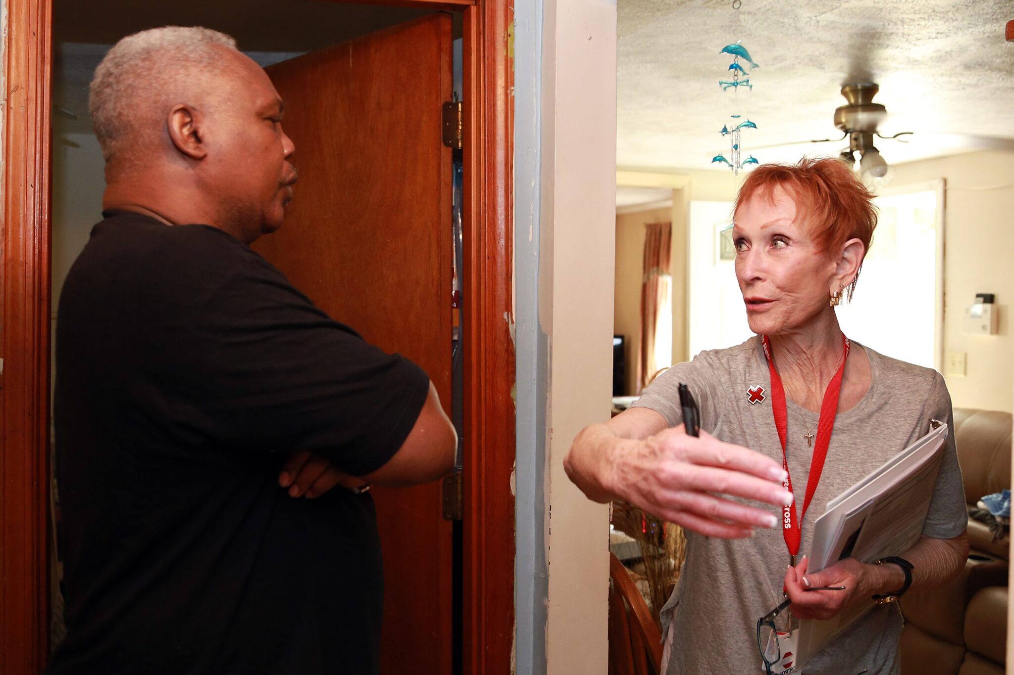 American Red Cross volunteer, Sandy Klein, reviews possible escape routes with homeowner, Carlton Wilson as part of the “Have a Plan” program.
