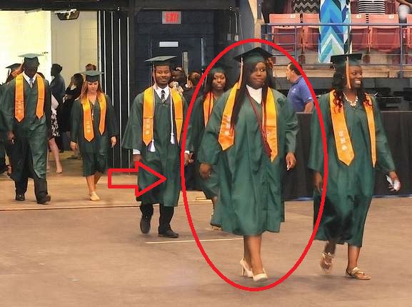 Qyamha proudly marches at her high school graduation.