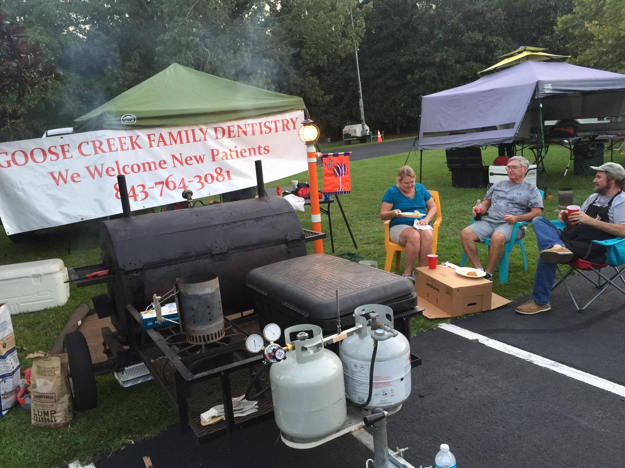 Jimmy Dennis of Jimbos BBQ & more enjoys the evening with his neighbors Danny and Jean and Sullivan of Goose Creek. 