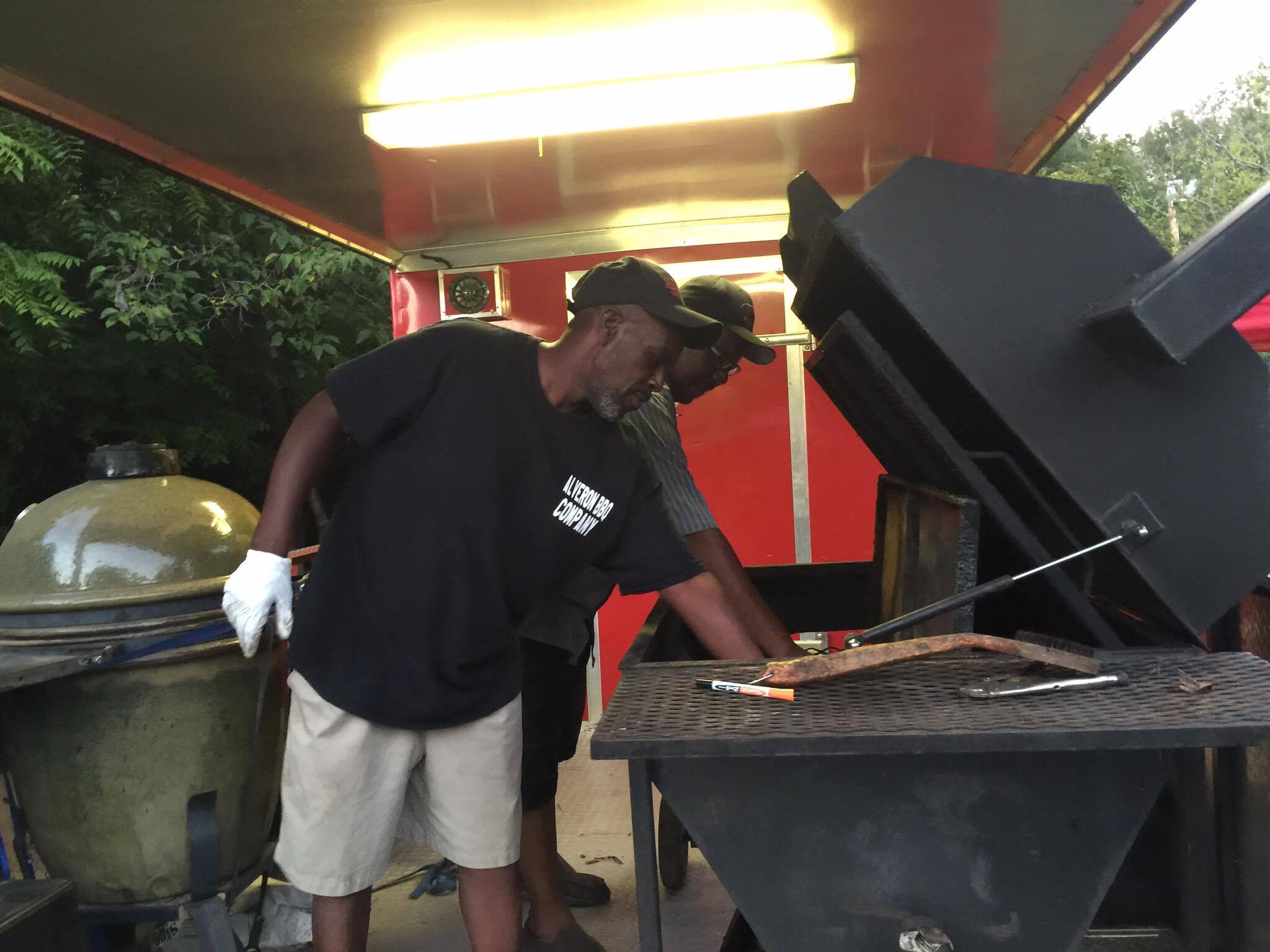 John Haney and Derrick Berry of Alveron Barbecue Company of Summerville prep the equipment for a long night of smoking. 