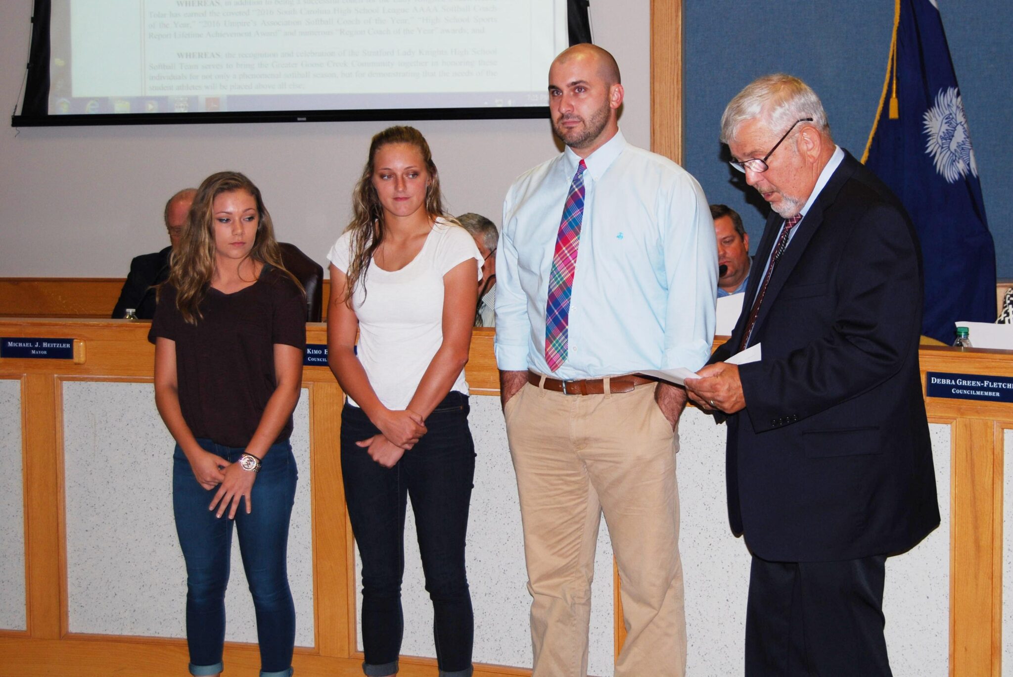 Pictured: Goose Creek Mayor Pro Tem Mark Phillips reads a resolution honoring the Stratford softball team during the Sept. 13 City Council meeting. Pictured from the team are Amber Orvin, Chloe Pelham and assistant coach Nic Riddle.