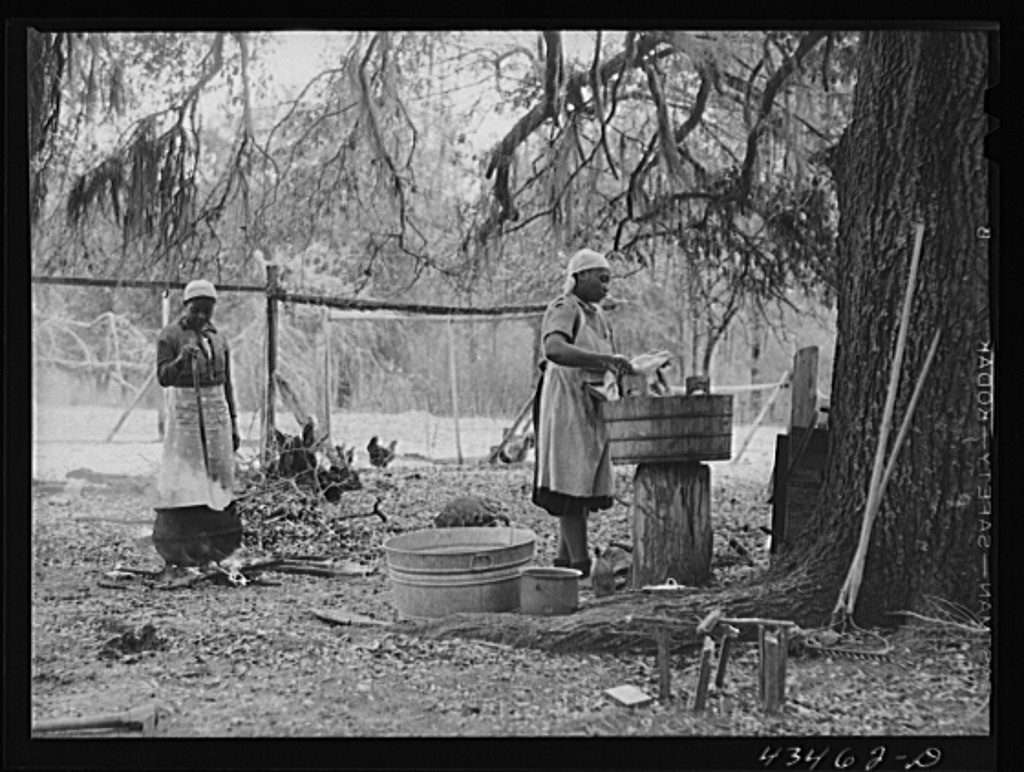Pictured: Family who had moved out of Santee-Cooper Basin, washing clothes on their "new" farm near Moncks Corner, South Carolina (Via Yale University)